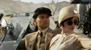 TOBEY MAGUIRE as Nick Carraway and ELIZABETH DEBICKI as Jordan Baker in Warner Bros. Pictures’ and Village Roadshow Pictures’ drama “THE GREAT GATSBY,” a Warner Bros. Pictures release.