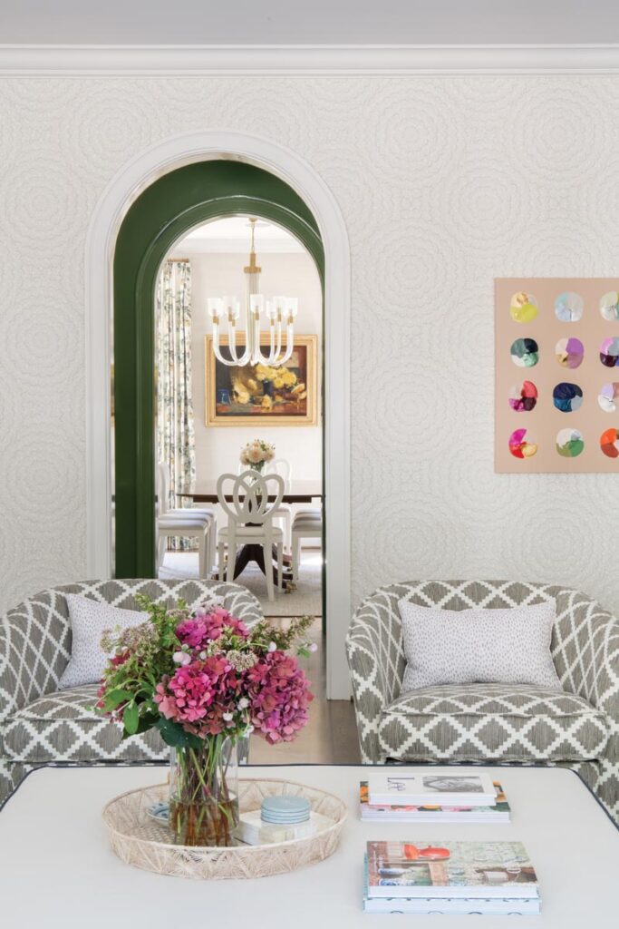 Elegant living room with patterned chairs and floral decor © Nashville Interiors