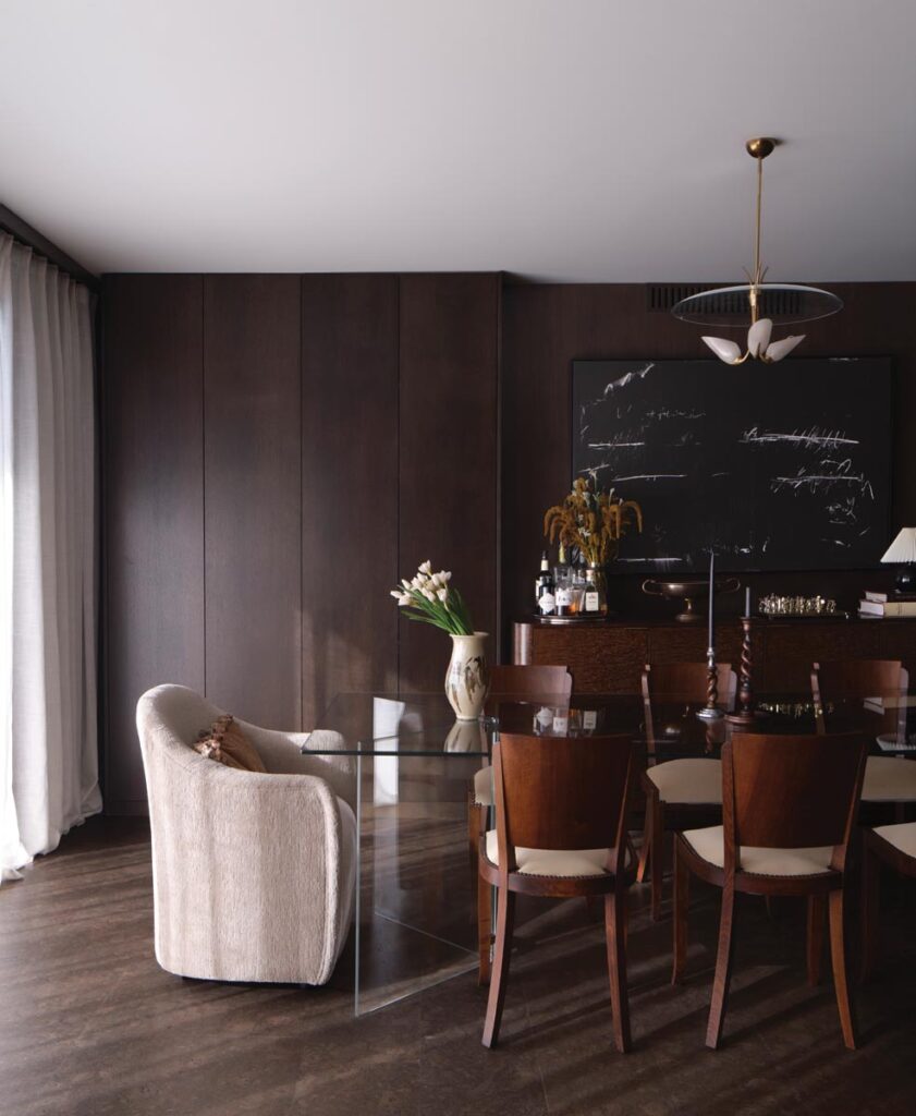 Elegant dining room with glass table and plush chairs © Nashville Interiors