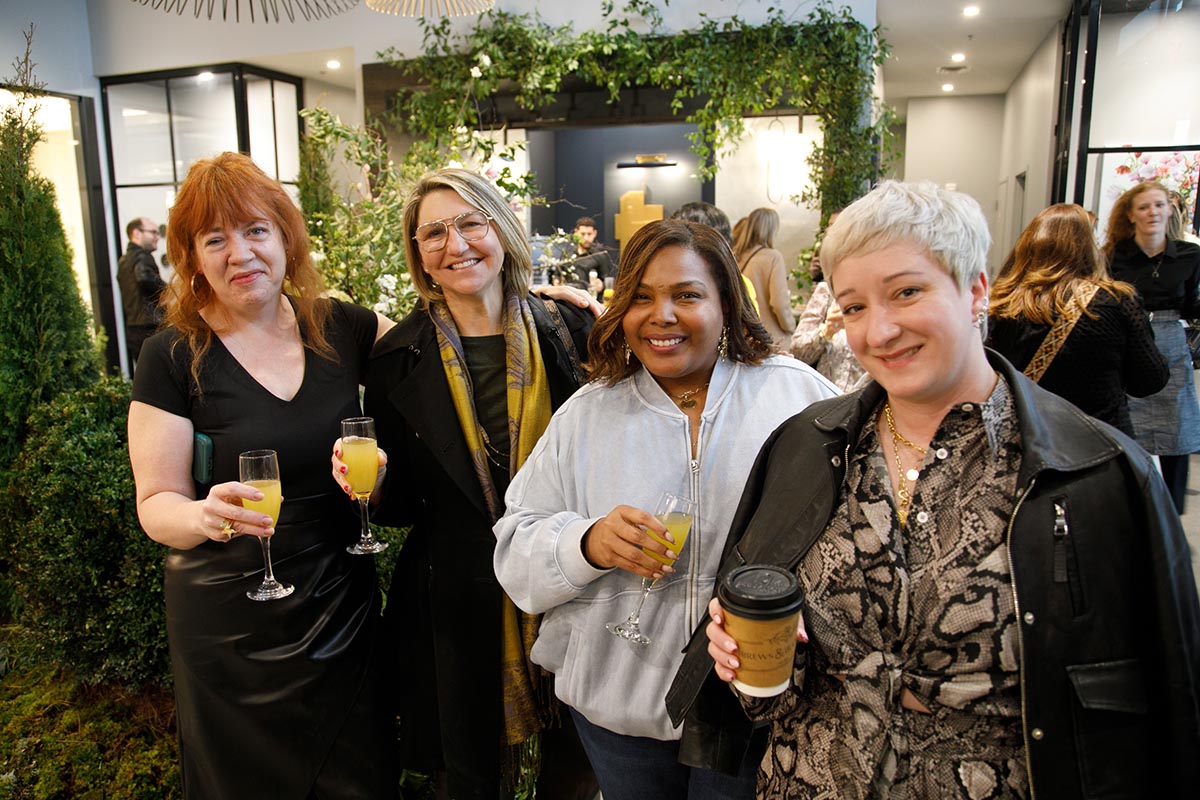 Group of four women enjoying drinks at a social event Photo by Nashville Interiors