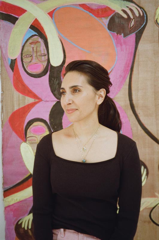 Portrait of a woman with abstract art background Photo by Nashville Interiors