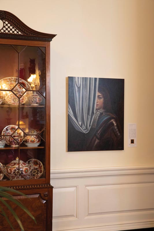 Elegant room with antique cabinet and portrait painting Photo by Nashville Interiors