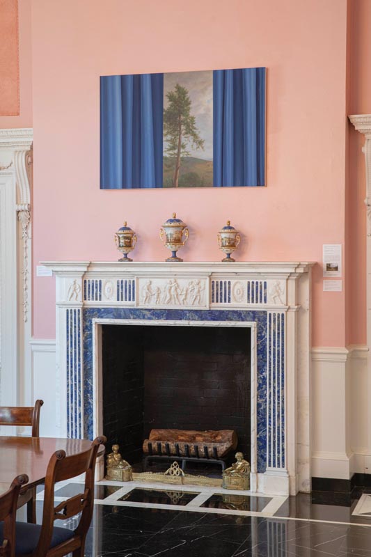 Elegant pink room with fireplace, blue painting, and ornate vases Photo by Nashville Interiors