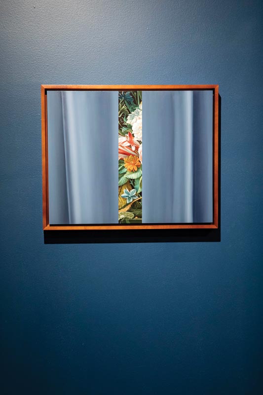 Artwork of floral panel between blue curtains in wooden frame Photo by Nashville Interiors