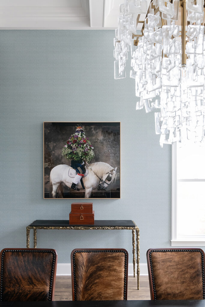Elegant dining room with chandelier and equestrian painting - Nashville Interiors